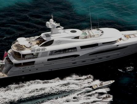 Superyacht cruising through deep blue waters besides smaller vessels.