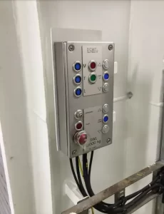 Cargo lift controls with multiple buttons including the emergency stop button