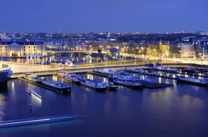 Amsterdam Marina at night with the street lights reflecting the yachts on the water