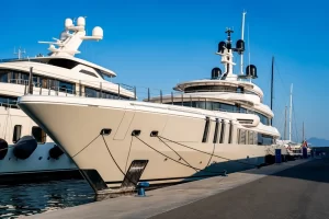 Superyachts docked in the marina on a bright day ready for a refit